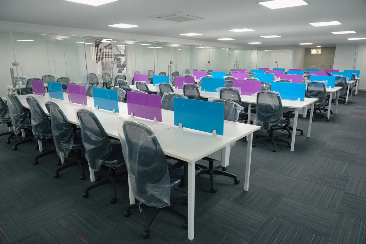 Shared desk row with ergonomic mesh chairs